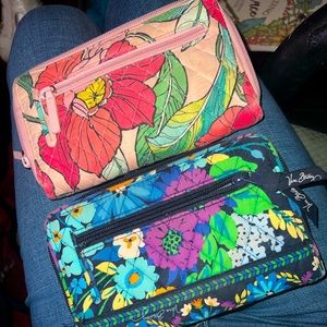 Two Vera Bradley wallets turn lock.